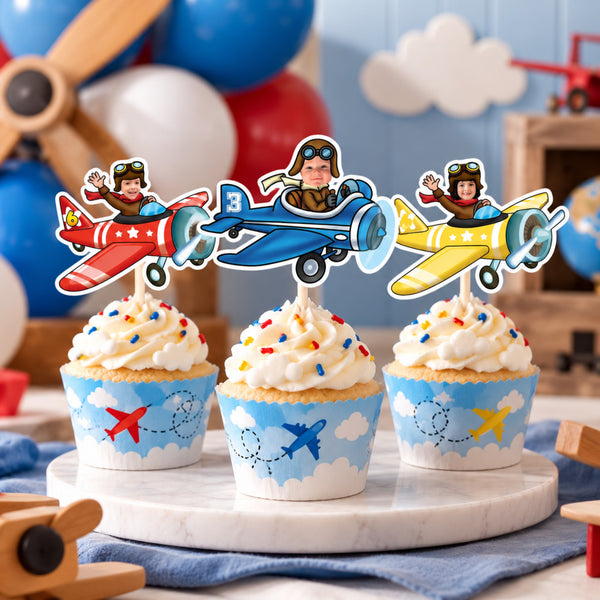 Personalized vintage airplane cupcake toppers with children's faces in red, blue and yellow planes on vanilla cupcakes with blue cloud wrappers