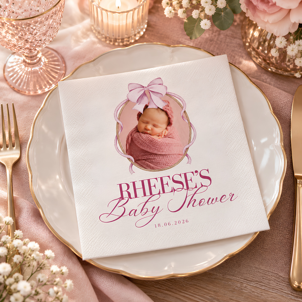 Custom pink baby shower napkin with baby photo in oval frame, name and date on a gold-rimmed plate