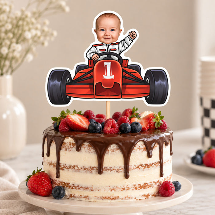 Custom face racing car cake topper on a chocolate drip birthday cake with fresh berries for a first birthday party